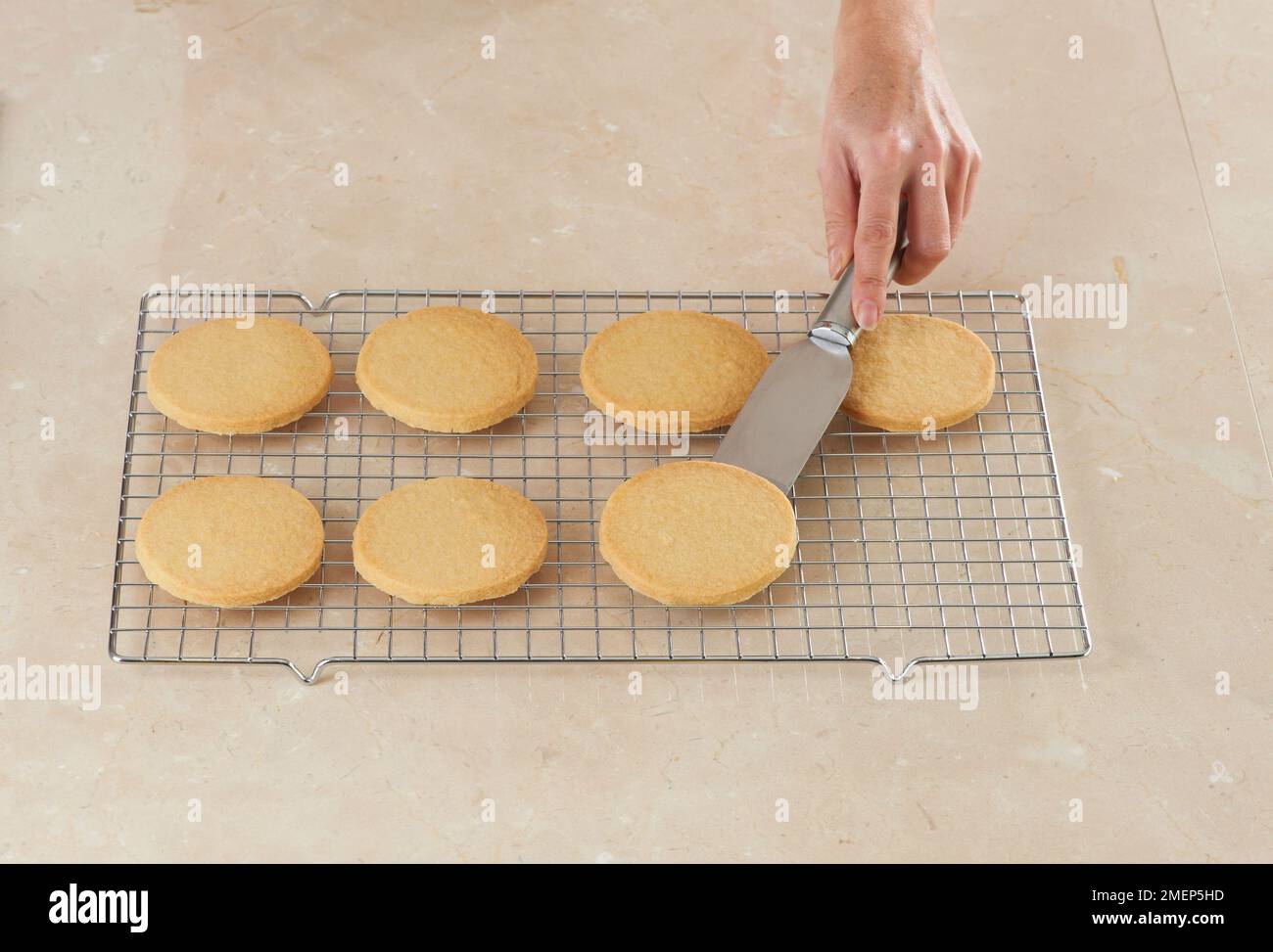 Making Butter Biscuits, transferring baked biscuits onto cooling rack Stock Photo Alamy