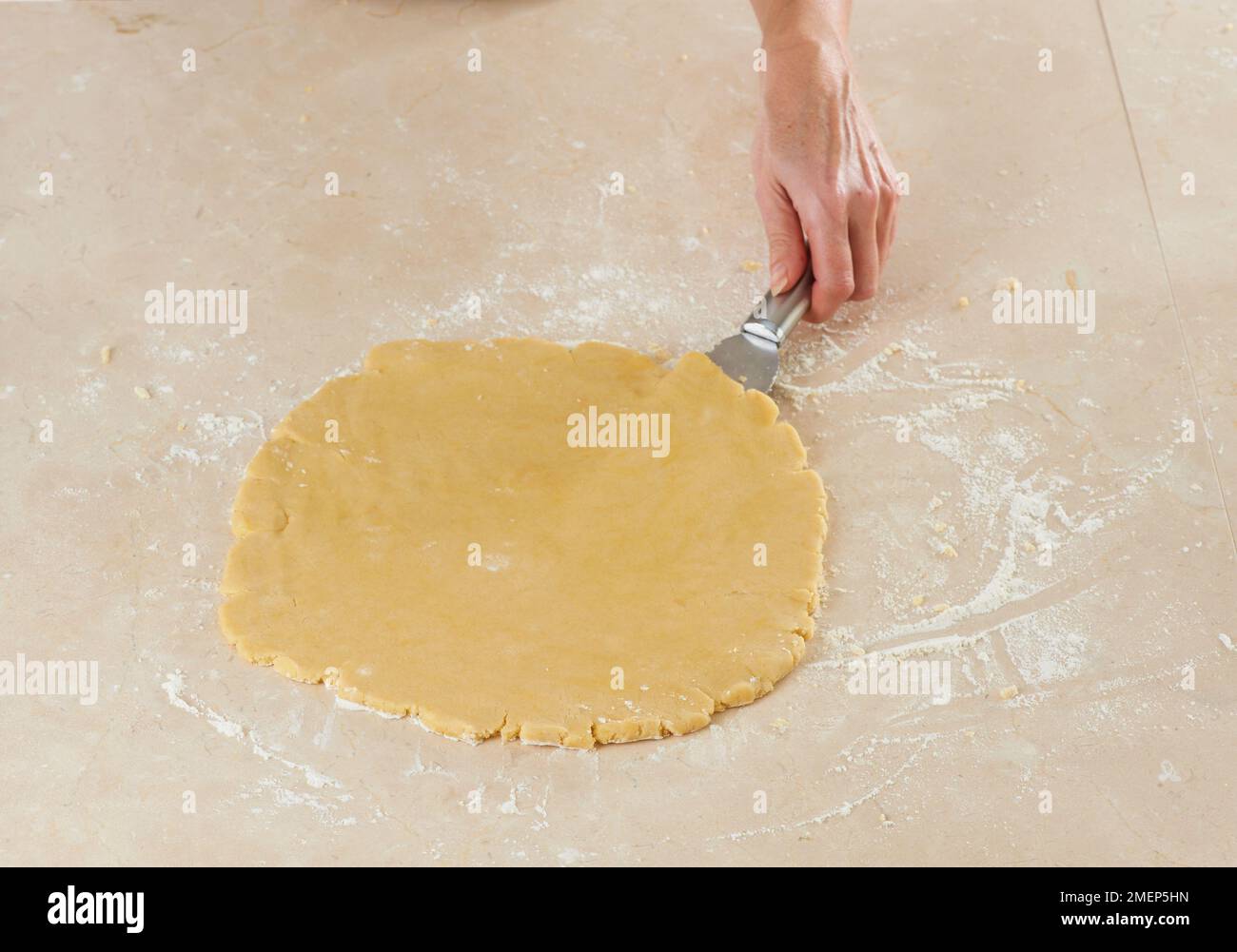 Making Butter Biscuits, using palette knife to move dough around, to