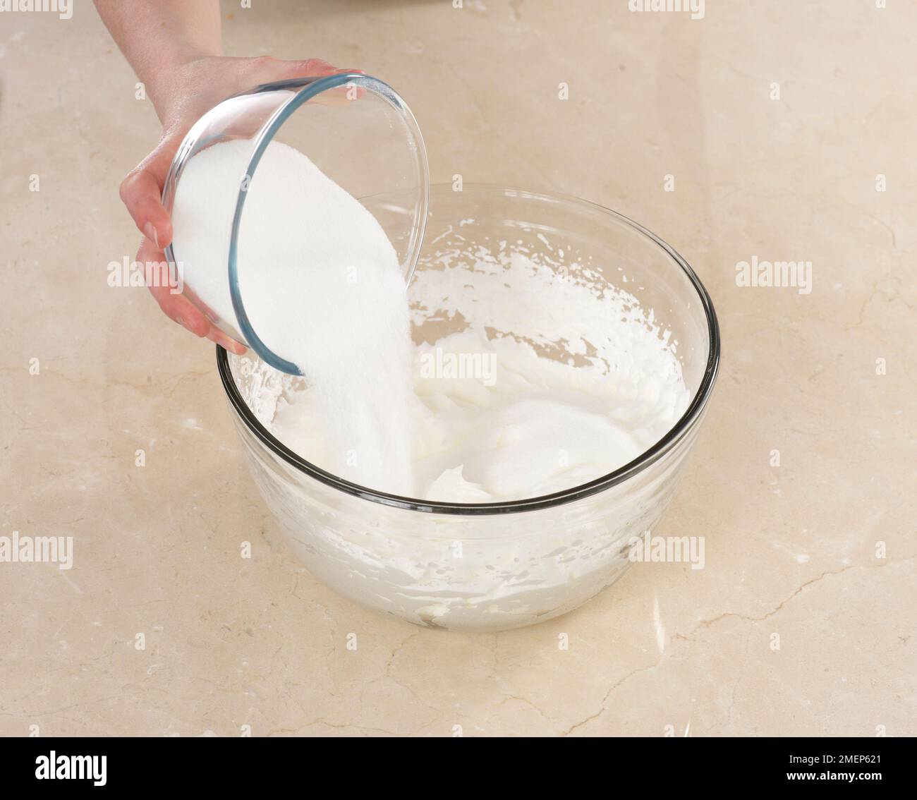 Making meringues, adding sugar to stiffened egg whites Stock Photo Alamy