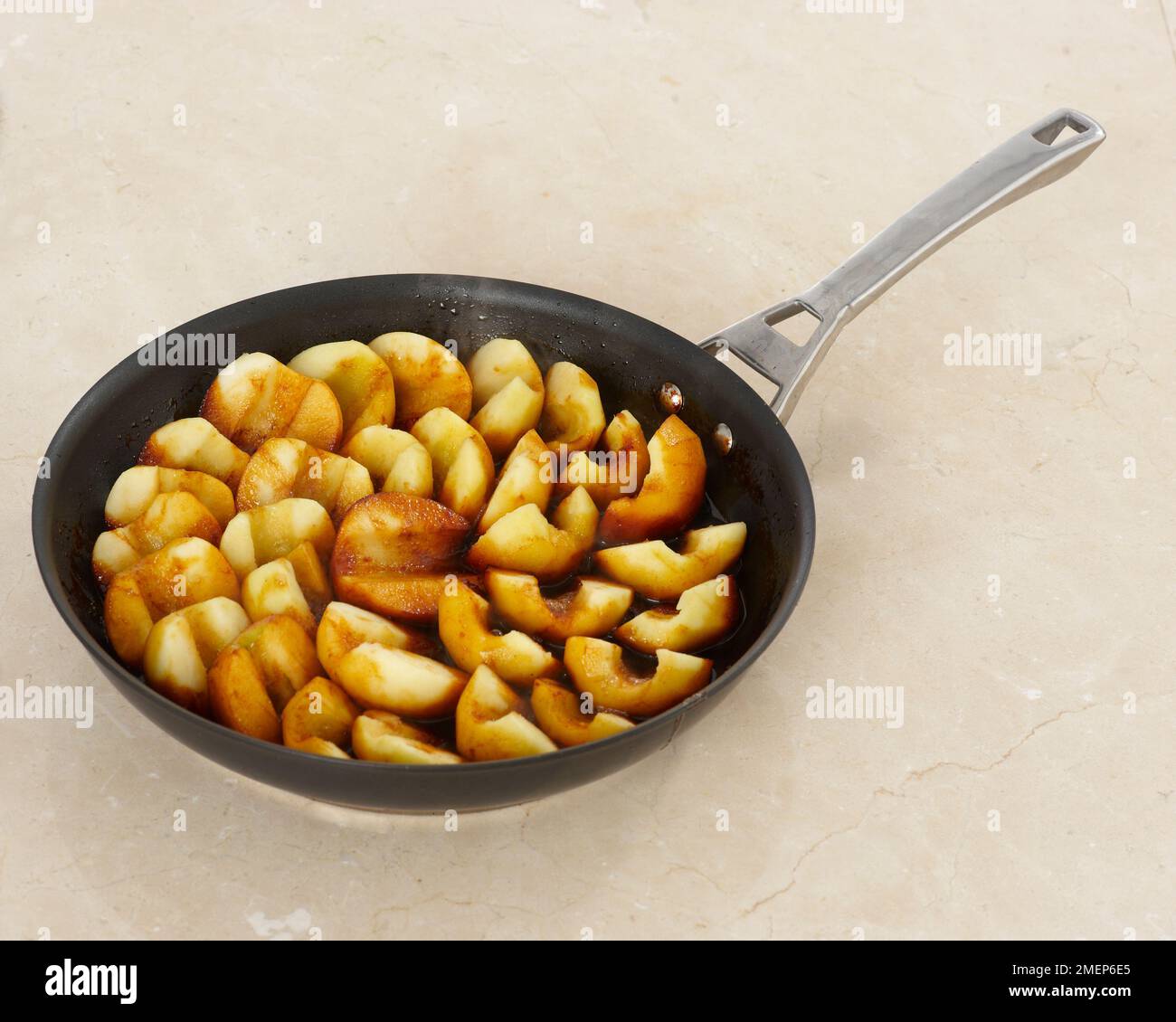 Making Tarte Tatin, caramelized apples in ovenproof pan Stock Photo Alamy