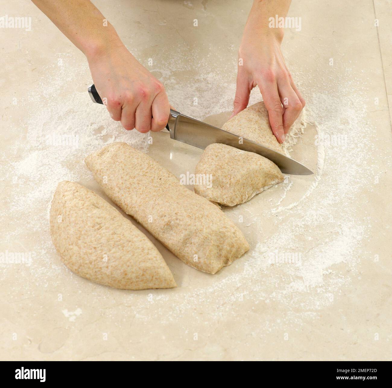 Wholemeal Cottage Loaf, cutting dough into pieces Stock Photo