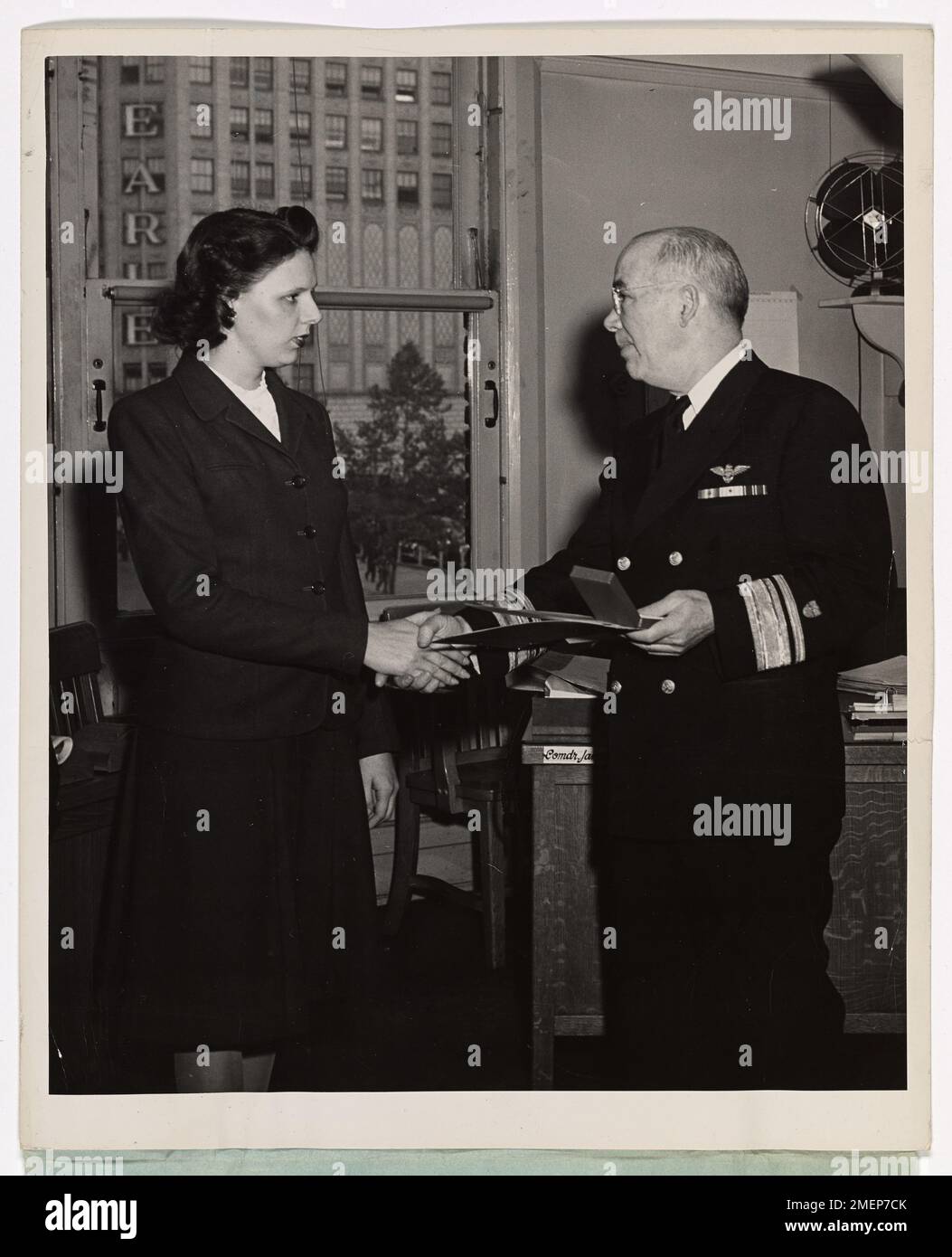 Rear Admiral Presents Purple Heart to Coast Guardsman's Widow. Rear Admiral Robert Donohue, U.S. Coast Guard, presents the Purple Heart to Mrs. Mary D. Kelley, civilian employee of the U.S. Coast Guard, whose husband, Coast Guardsman William J. Kelley, Jr. , storekeeper first class, died when his ship was torpedoed in the North Atlantic. Mrs. Kelley lives in Washington, D.C. Coast Guardsman Kelley's parents are Mr. Mrs. William J. Kelley , Sr., of Silver Spring, M.D. His brother is Captain James Ford Kelley, U.S. Army Air Forces. Stock Photo