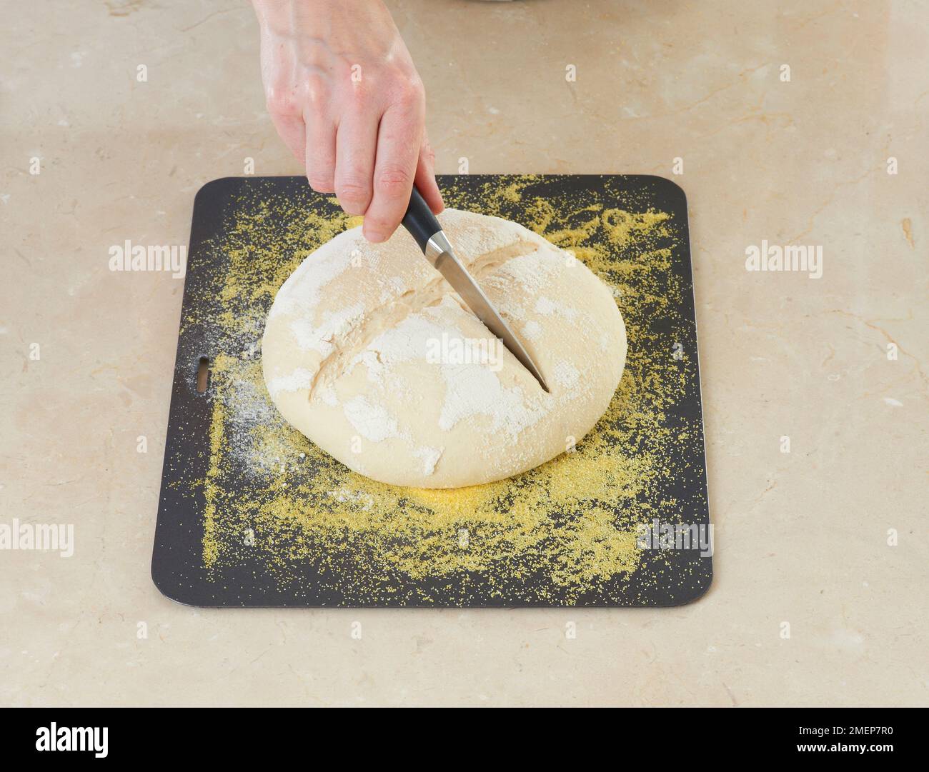 Making Sourdough bread, making criss-cross slashes in the dough Stock ...