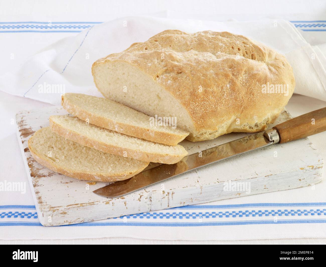 https://c8.alamy.com/comp/2MEP814/sliced-pugliese-bread-on-wooden-chopping-board-with-bread-knife-2MEP814.jpg