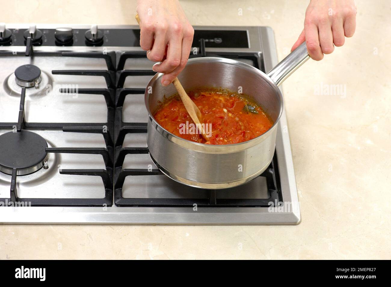 Cooking tomato sauce for pizza base Stock Photo Alamy