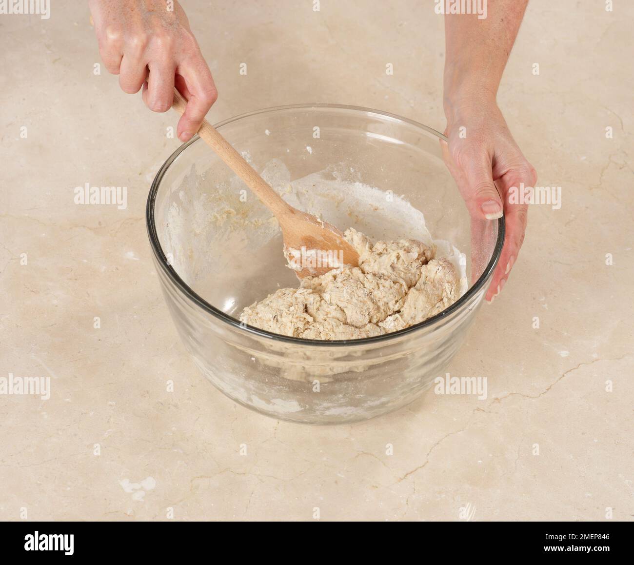 Combining ingredients for pitta bread dough Stock Photo