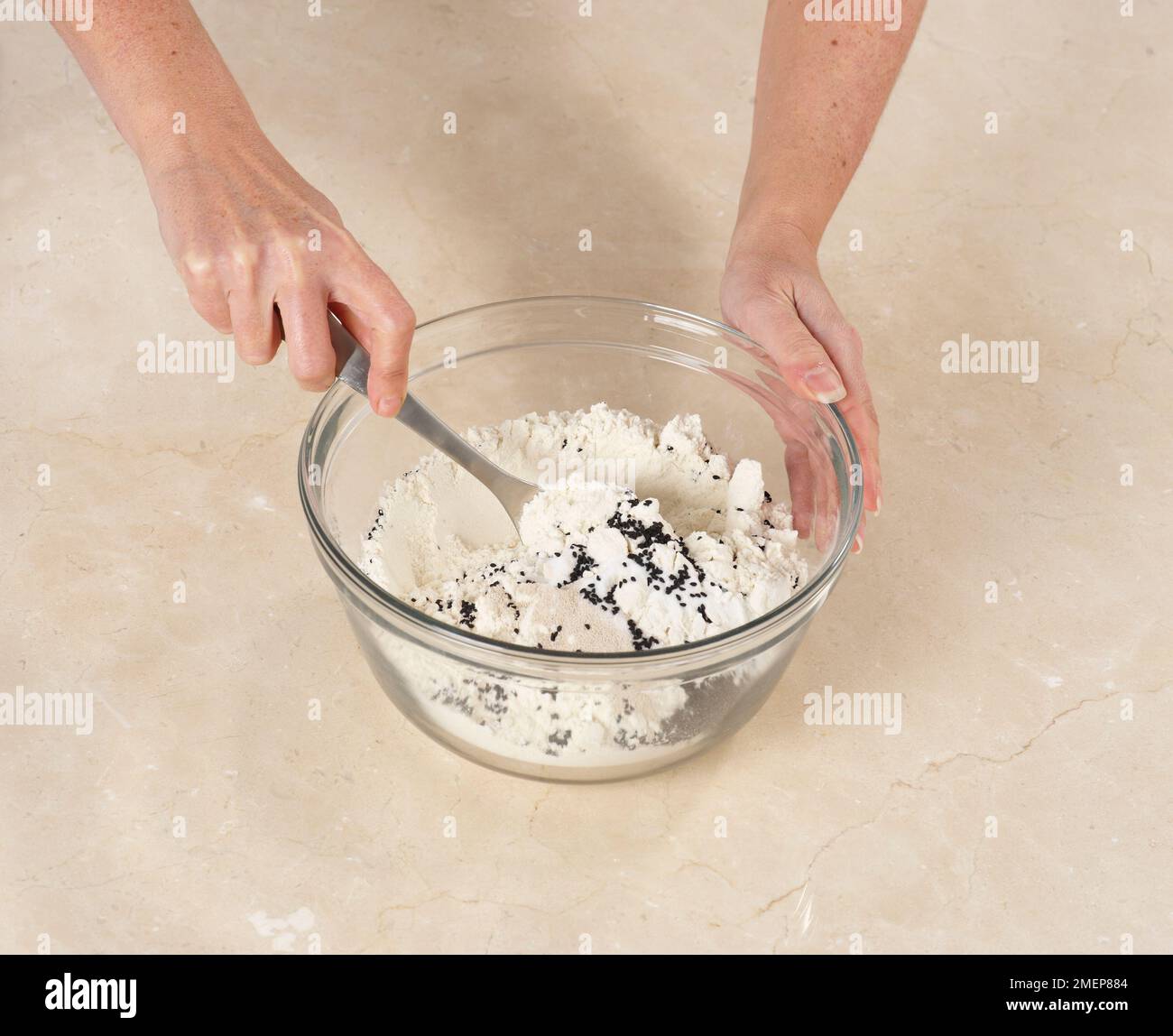Making Naan Bread, mixing together flour, yeast, sugar, salt, and onion