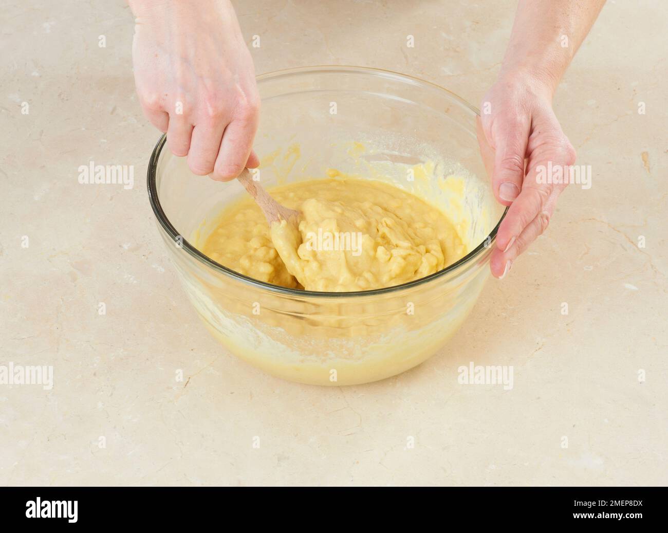 Mixing together ingredients of hot-water crust pastry dough, using wooden  spoon Stock Photo - Alamy