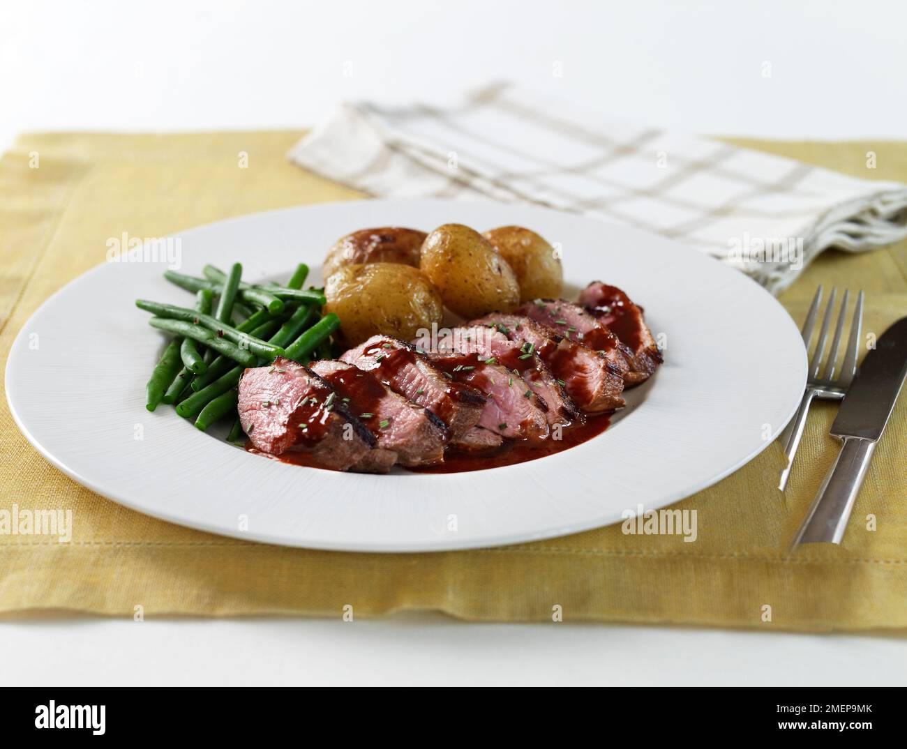 Duck in red wine with green beans and potatoes Stock Photo - Alamy