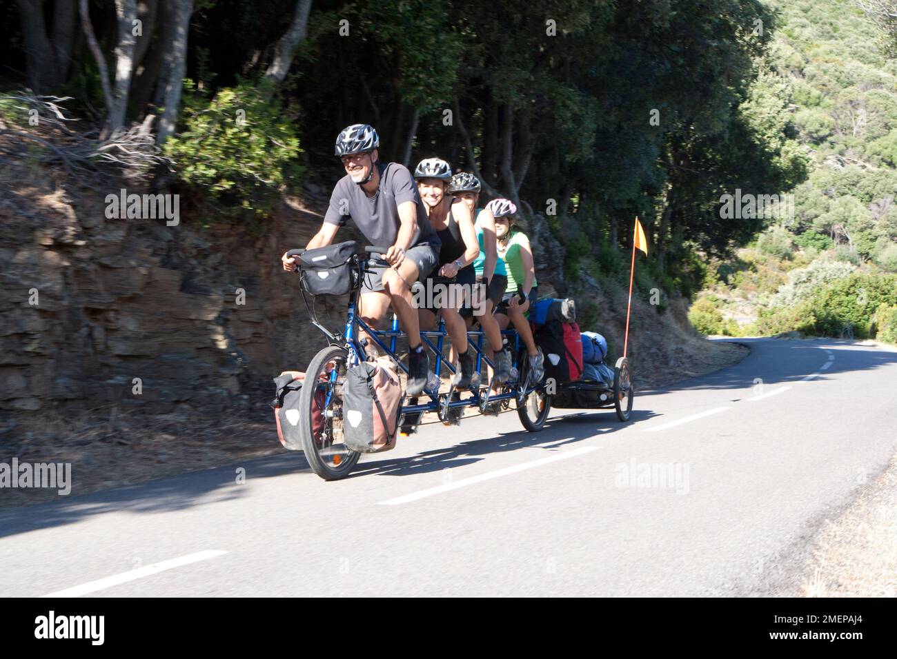France, Corsica, Cap Corse, family of four on tandem bicycle Stock Photo