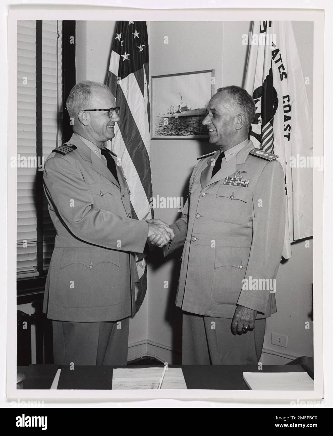 Rear Admiral Frank A. Leamy, USCG. Captain Harold C. Moore, Chief of Staff of the Ninth Coast Guard District congratulates Rear Admiral Frank A. Leamy, USCG, upon attaining his new two star rank of Rear Admiral. Rear Admiral Leamy assumed the command of the Ninth Coast Guard District on 1 September, 1954, relieving Rear Admiral Roy L. Raney who is now Commander, First Coast Guard District, Boston, Mass. Prior to taking over the Command of the Ninth District, Admiral Leamy was Commanding Officer of the Eighth Coast Guard District, New Orleans, La. Stock Photo