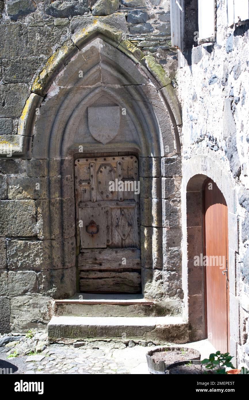 France, Auvergne, Cantal, Salers, gothic pointed arch door of church Stock Photo