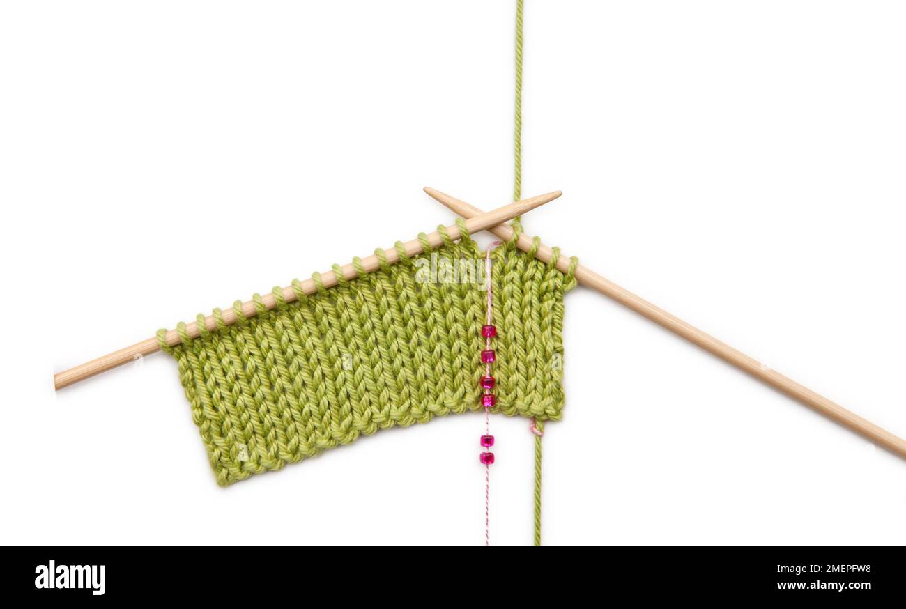 Using beads as stitch and row markers, knitting technique Stock Photo