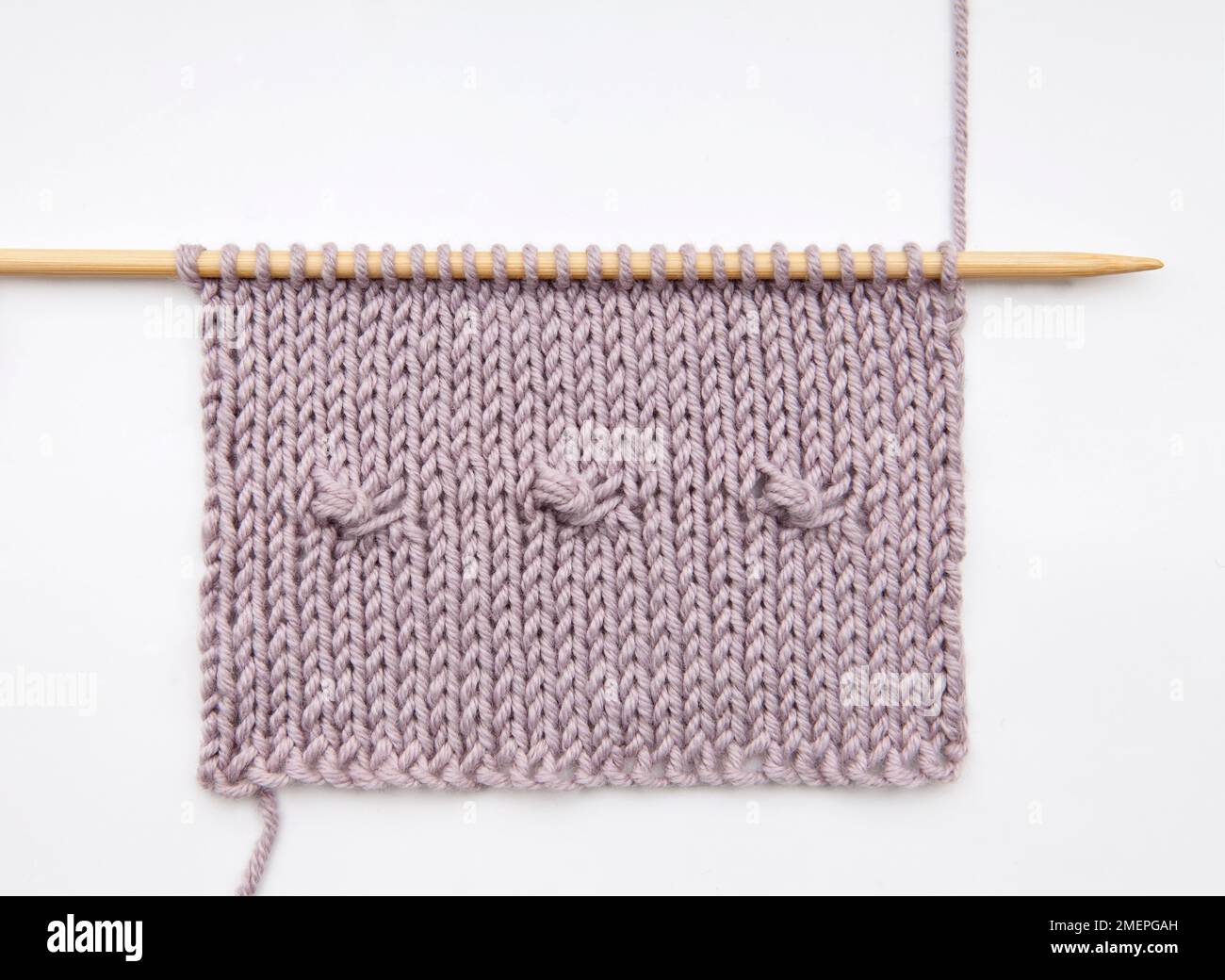 Three intothree stitch knitting technique sample Stock Photo Alamy