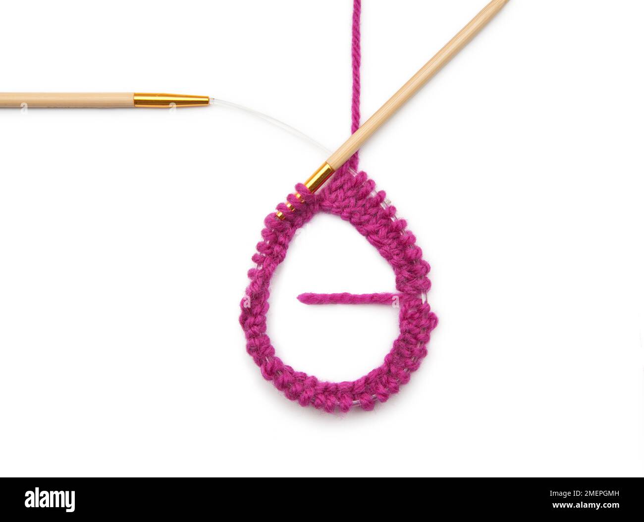 Example of working with a circular knitting needle - knitting a mobus loop Stock Photo