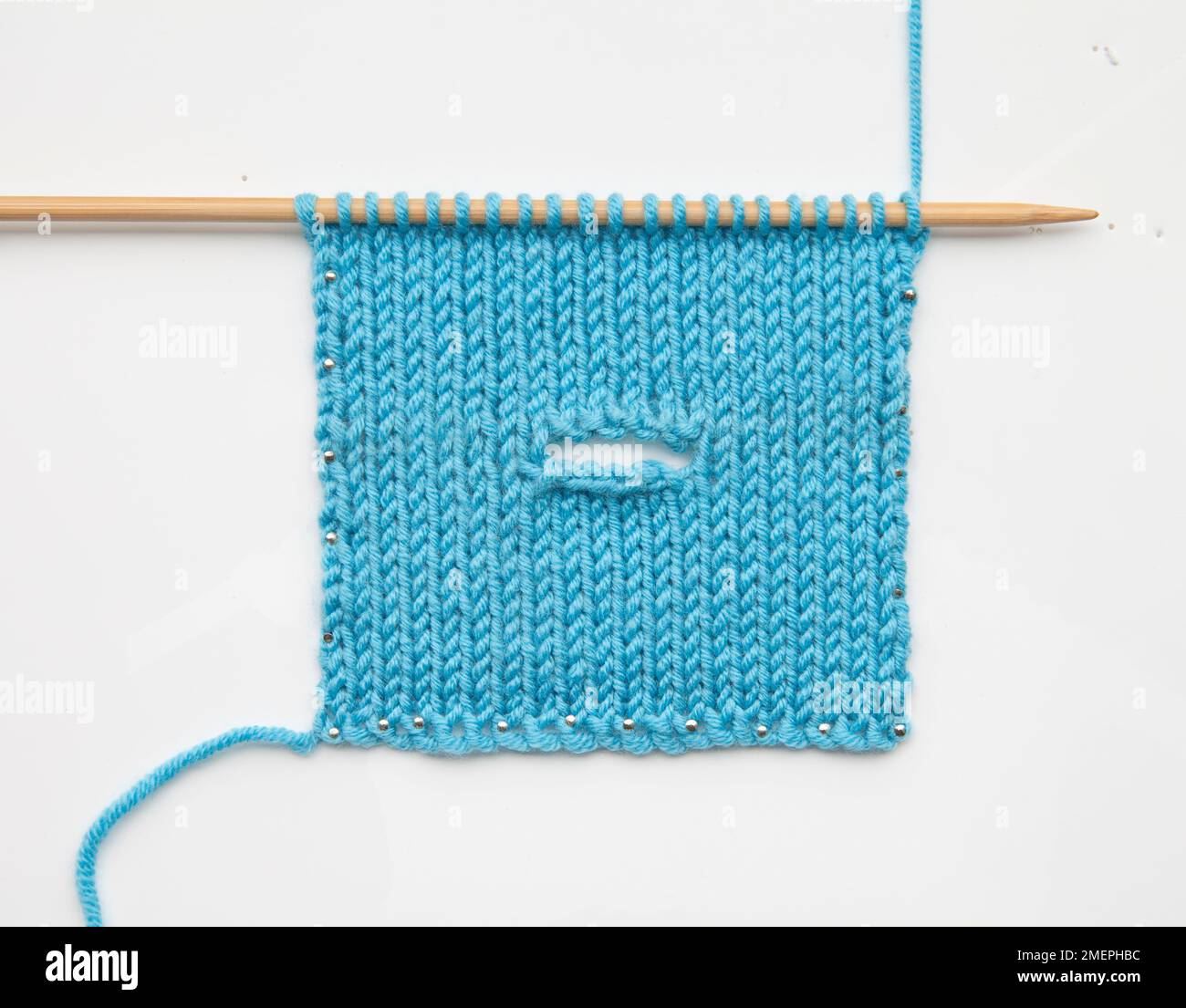 Example of castoff horizontal buttonhole knitting technique Stock