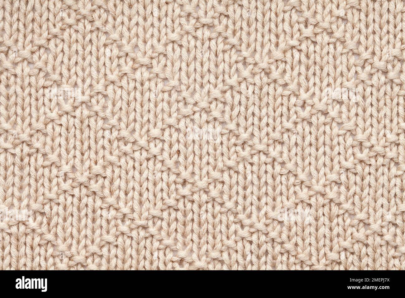 Knit and purl diamonds on rowan lenpur linen blanch baby blanket, close