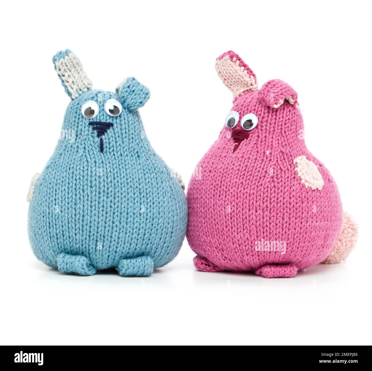 Knitted blue and pink wool cotton bunny rabbit toys, close-up Stock Photo