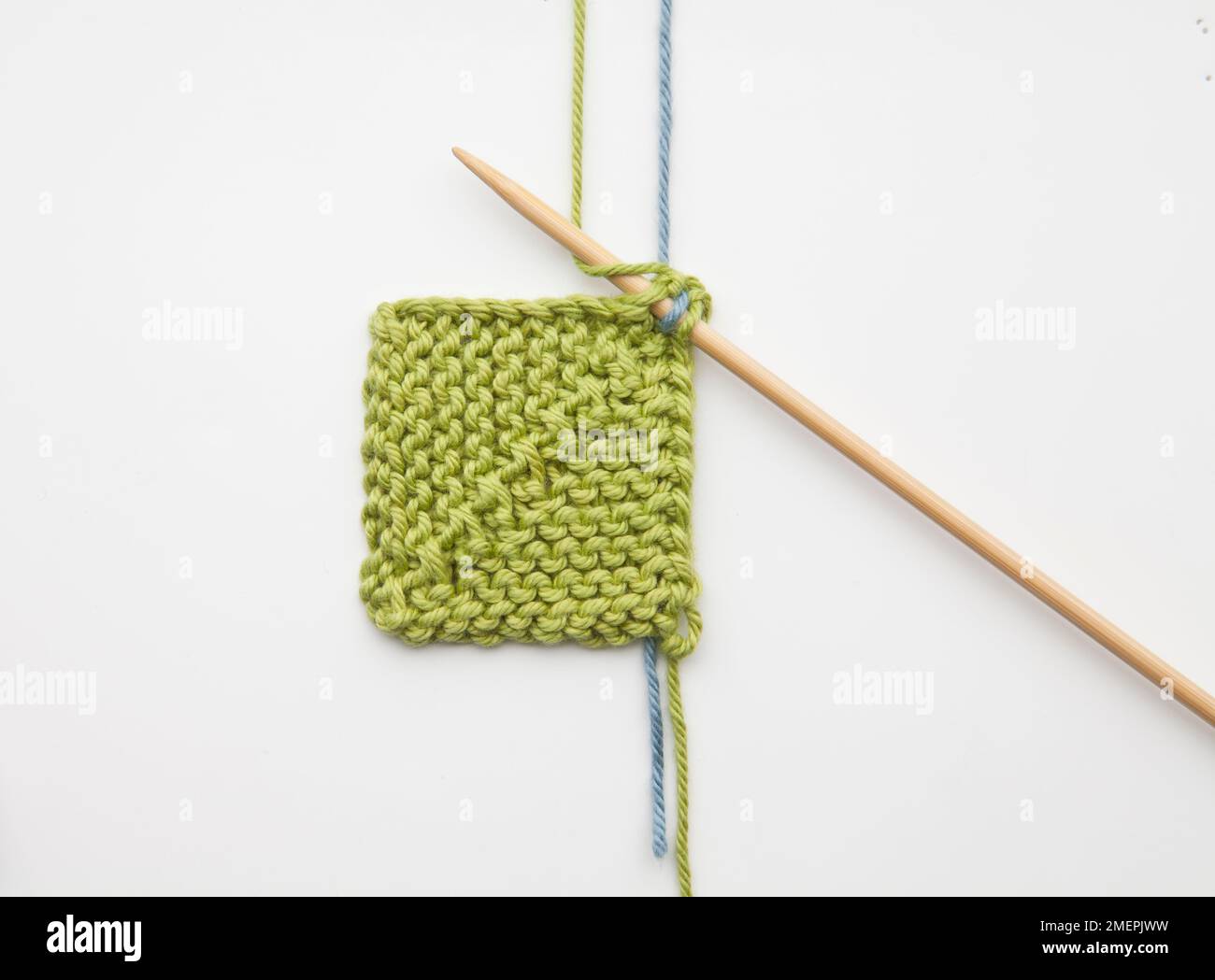 Weaving in ends during domino knitting Stock Photo Alamy