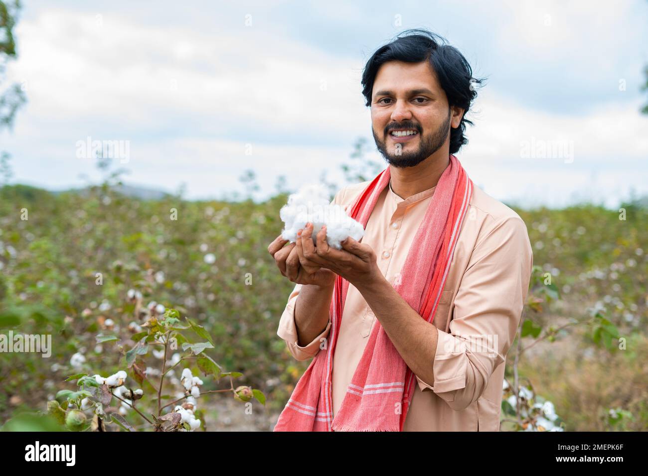 happy smiling turning by holding cotton while looking cameraat cotton