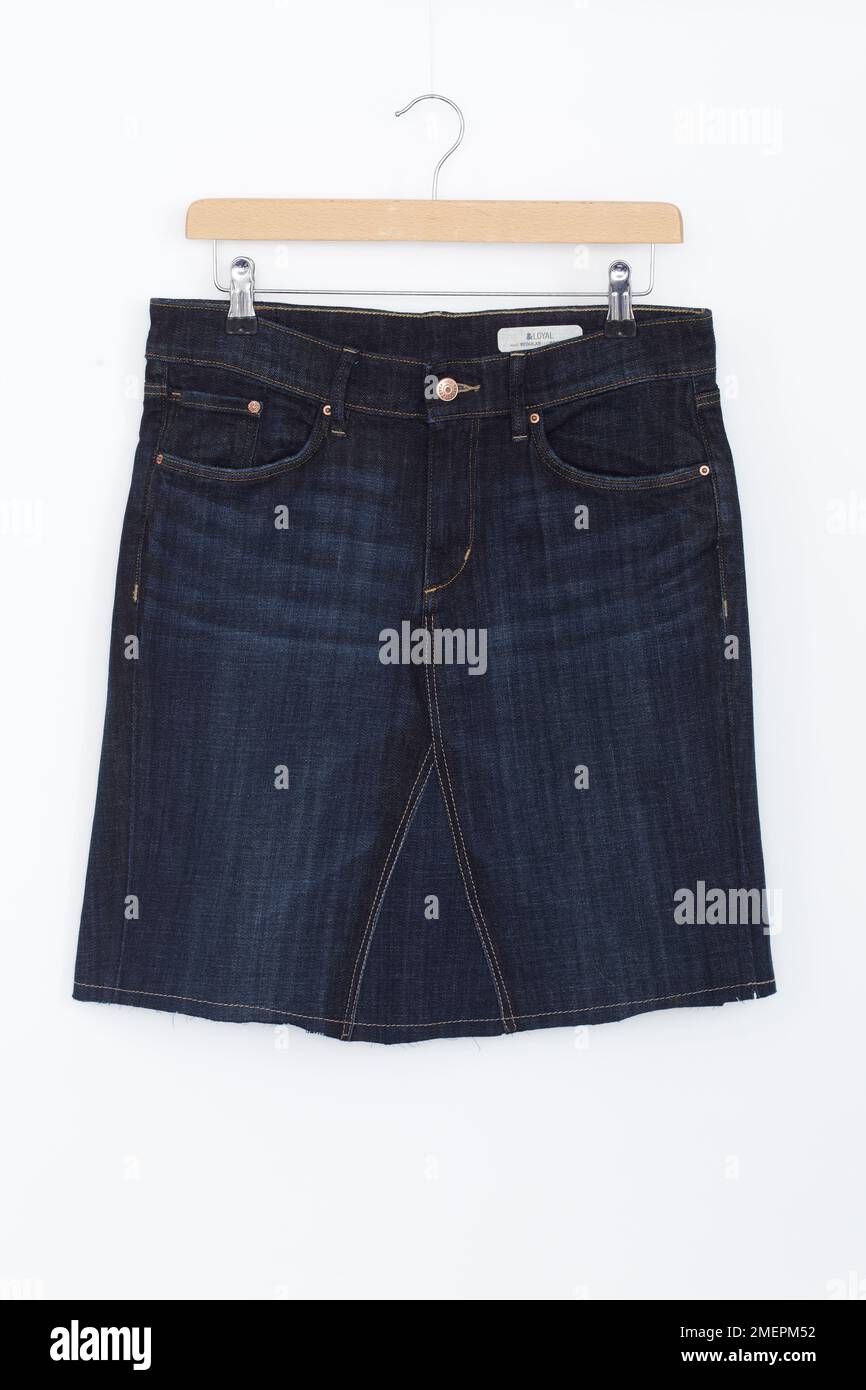 Denim skirt made from pair of jeans on hanger, close up Stock Photo