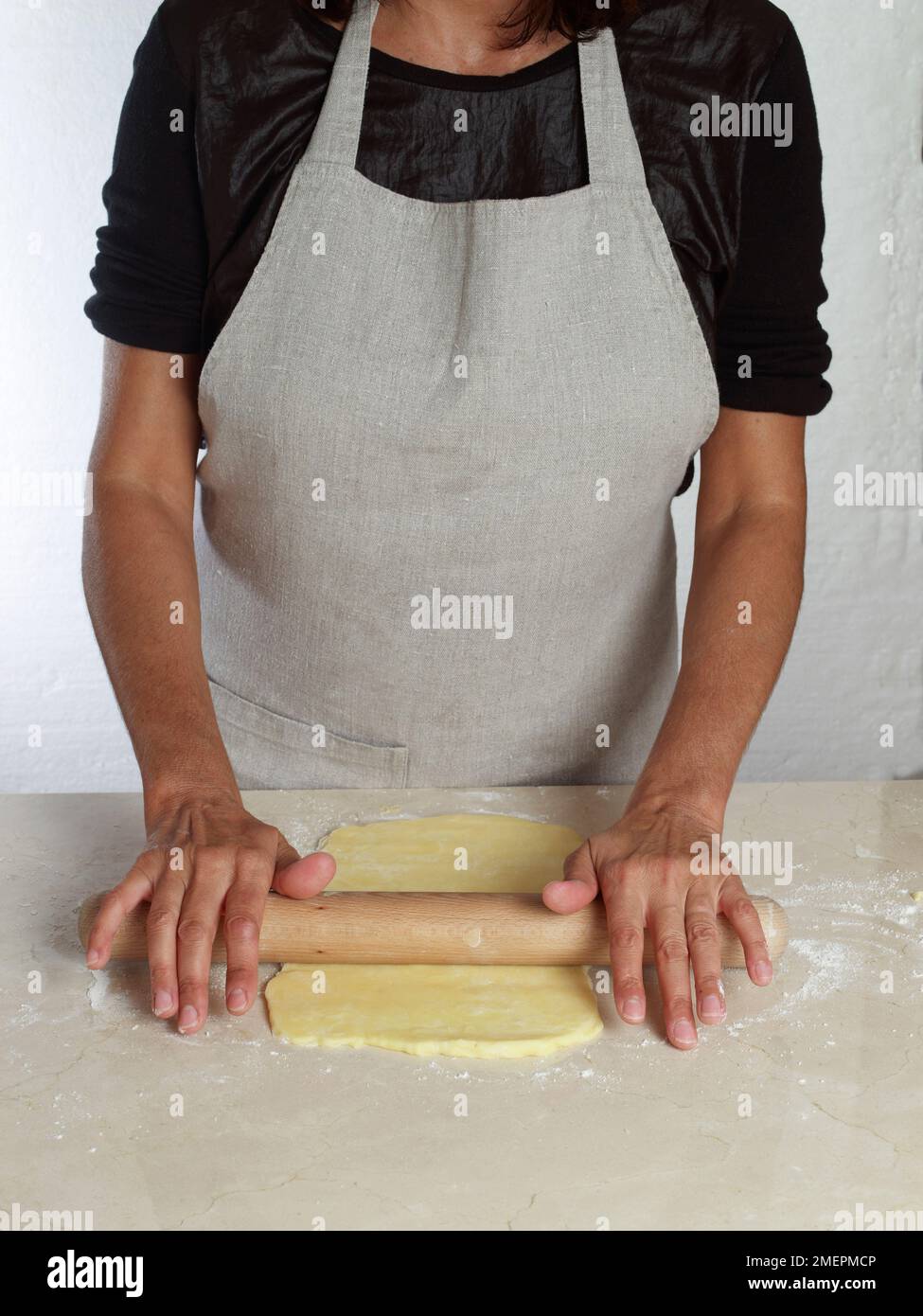 Making gluten free puff pastry, rolling out the chilled dough Stock