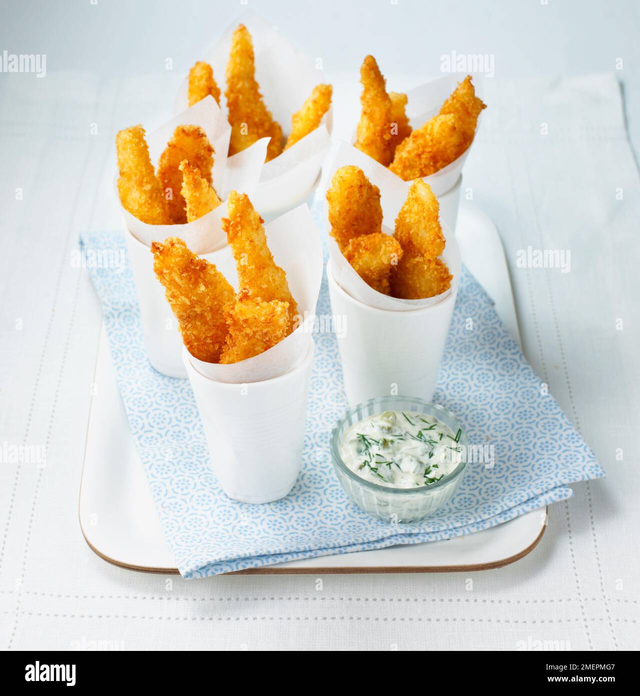 Goujons (deep fried fish) wrapped in paper, served with tartar sauce