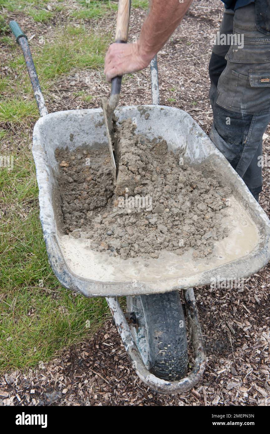 Mixing cement in wheelbarrow Stock Photo Alamy