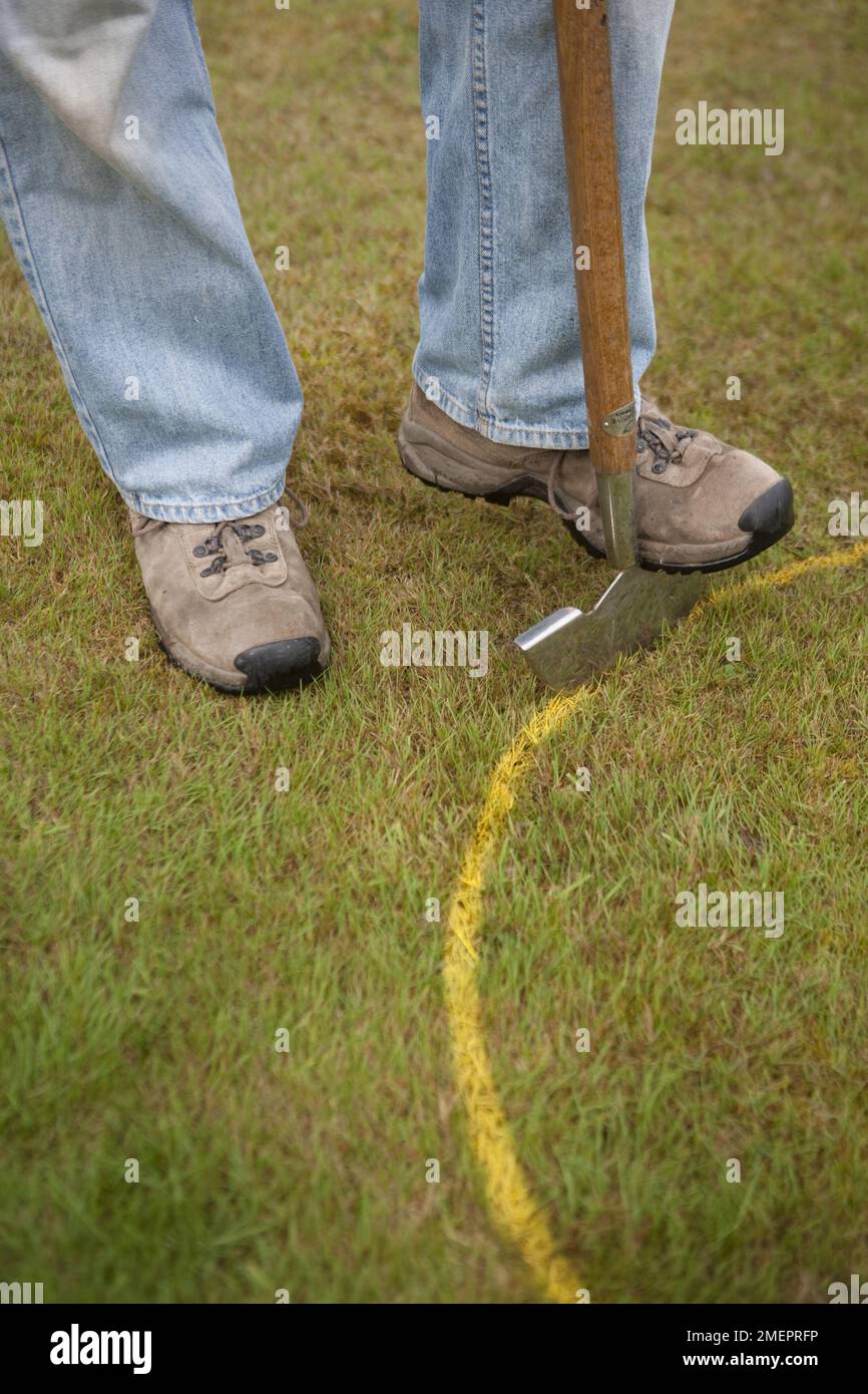 Digging around a circle drawn on a lawn Stock Photo