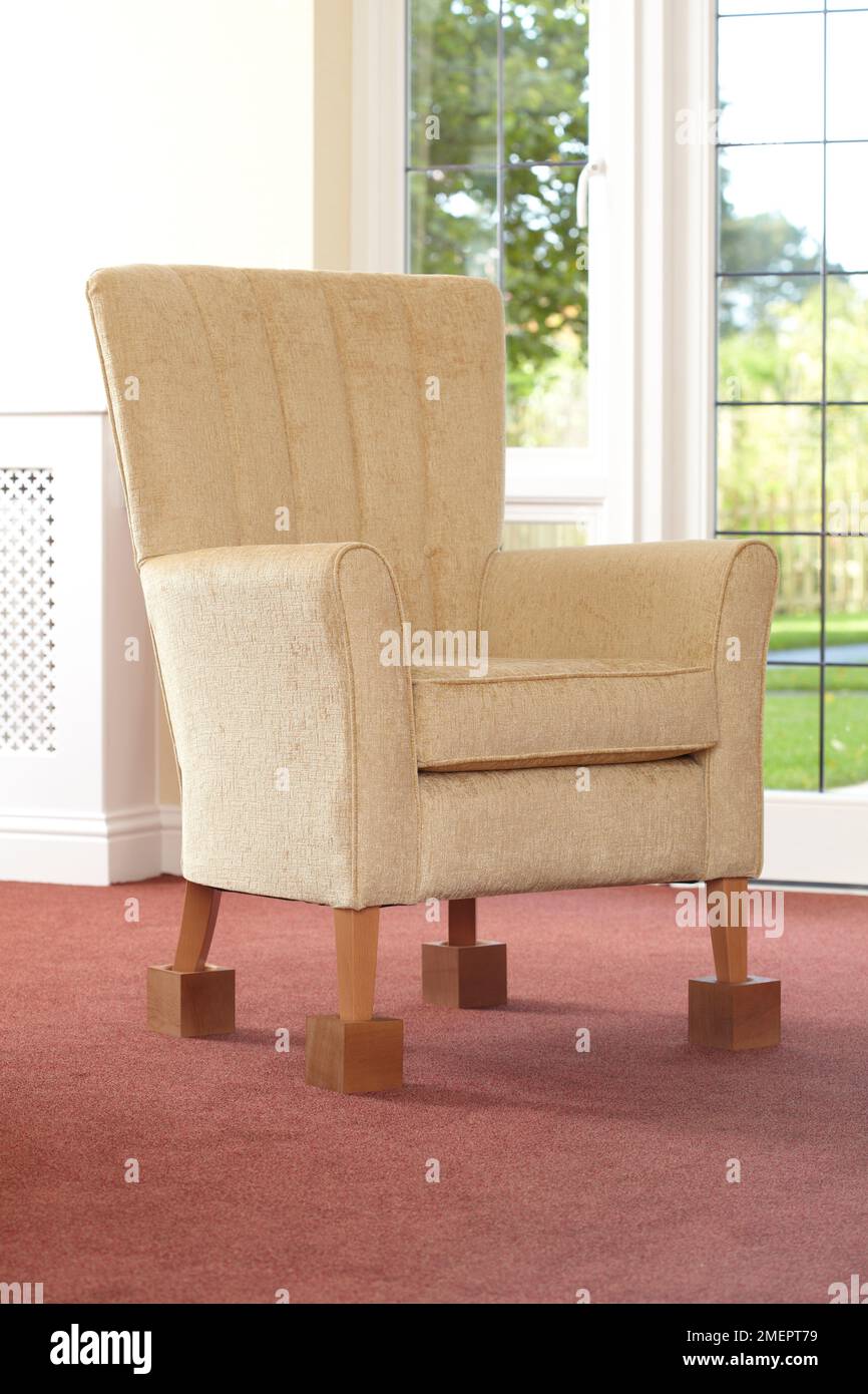 Armchair raised on blocks Stock Photo Alamy