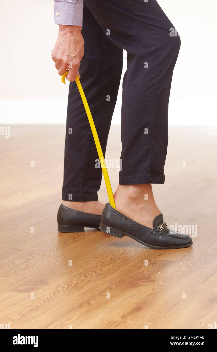 Using a shoe horn Stock Photo Alamy