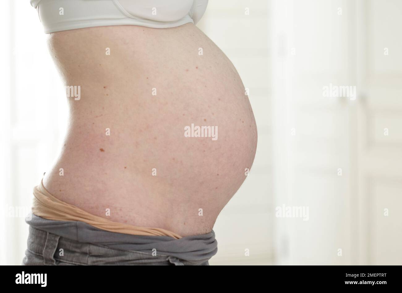 Pregnant woman's stomach, side view Stock Photo