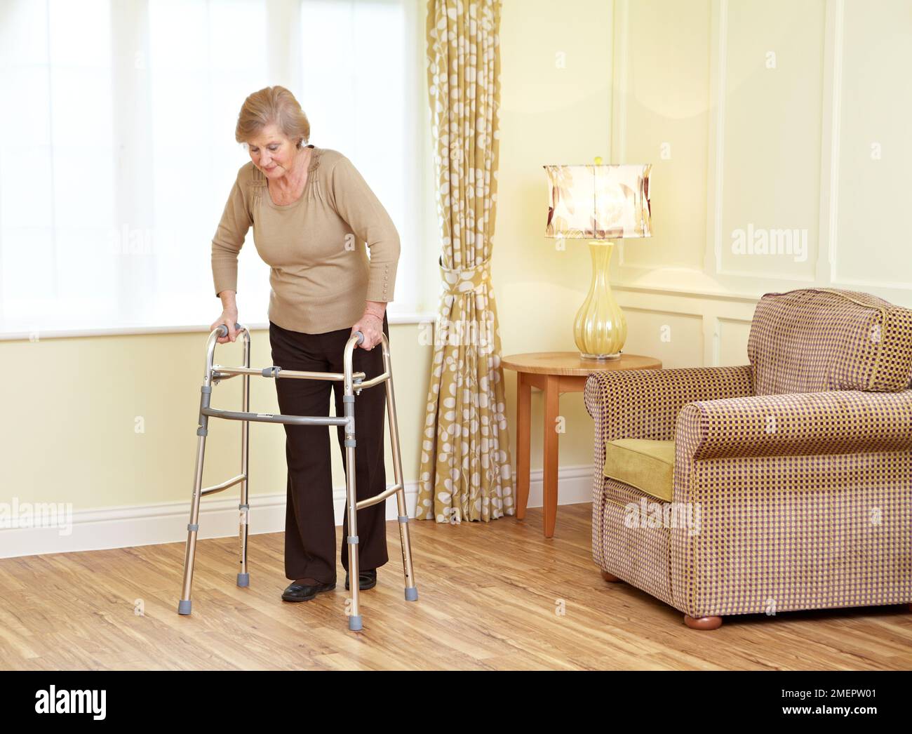 Using a walking frame Stock Photo Alamy