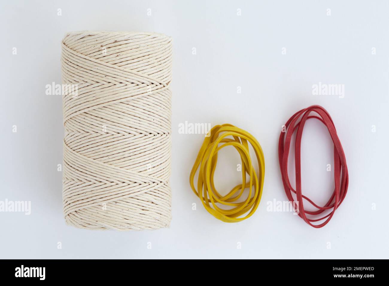 Rubber bands and reel of string, closeup Stock Photo Alamy