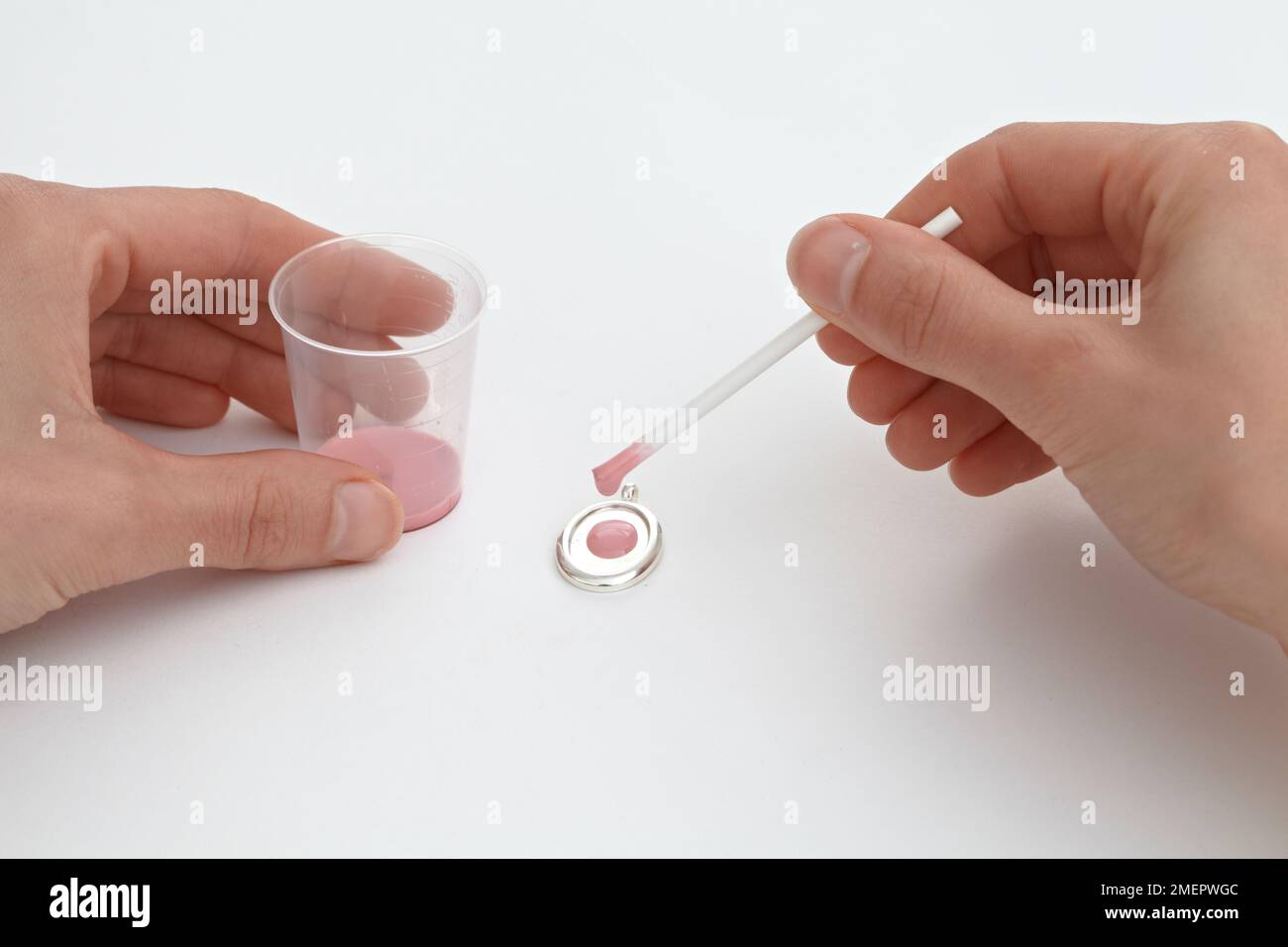 Applying enamel to bezel using mixing stick, closeup Stock Photo Alamy