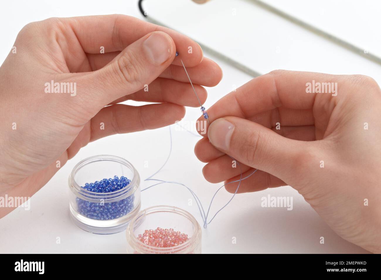 Beading mat with finished designs, needles and colourful beads Stock Photo  - Alamy