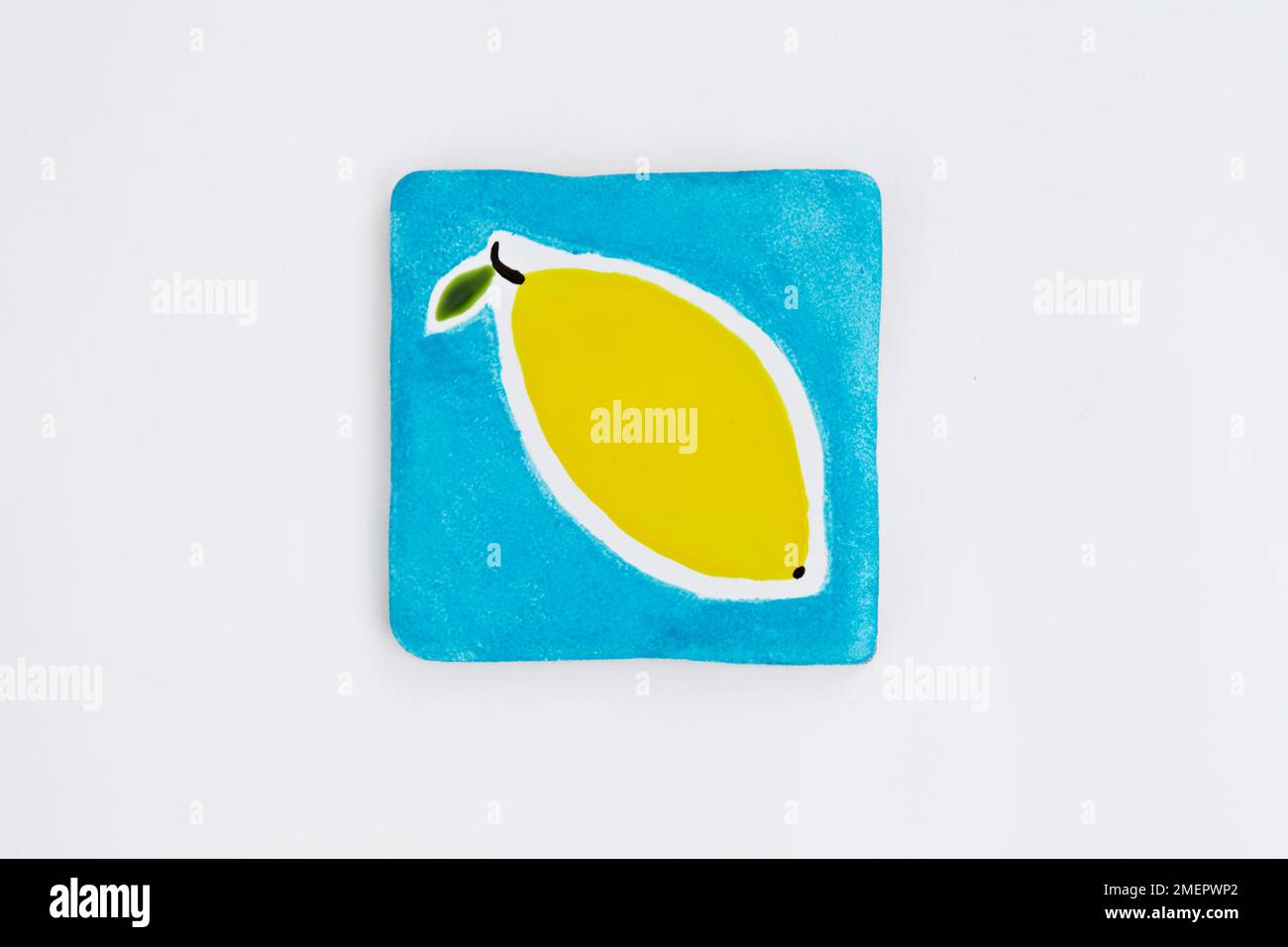 Smaller ceramic coaster decorated with lemon, overhead view Stock Photo