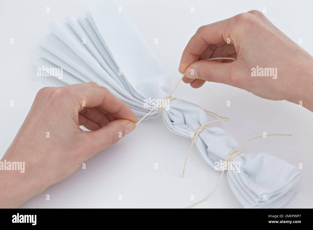 Preparing fabric for striped effect tiedying, binding the pleated