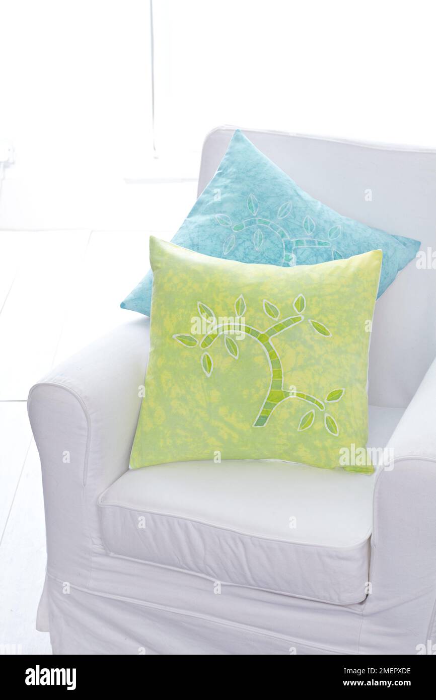 Batik cushions on white armchair, close- up Stock Photo