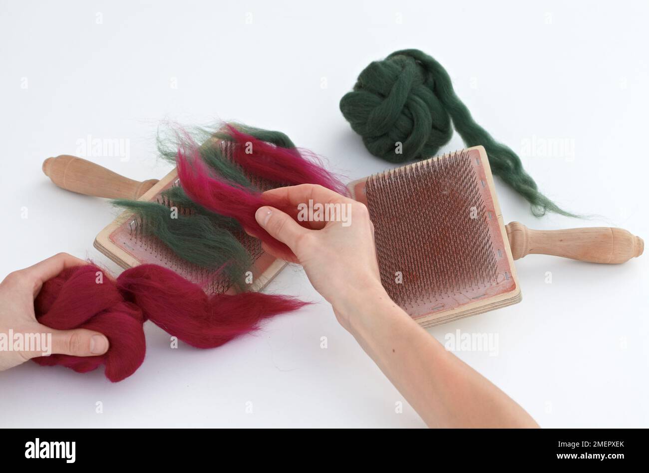 Placing fleece fibres on carder to colour-blend, close-up Stock Photo