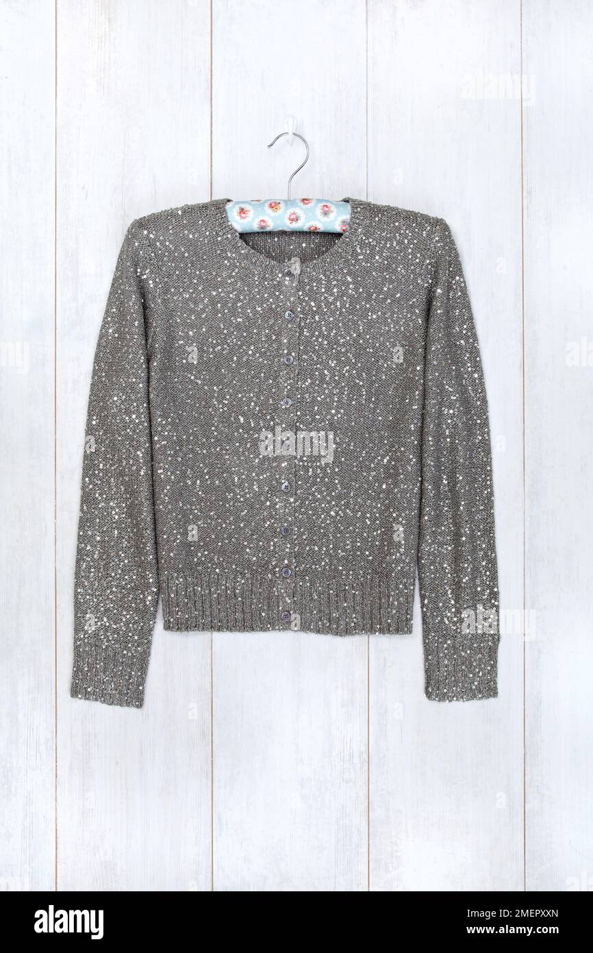 Cardigan on coat hanger, closeup Stock Photo Alamy