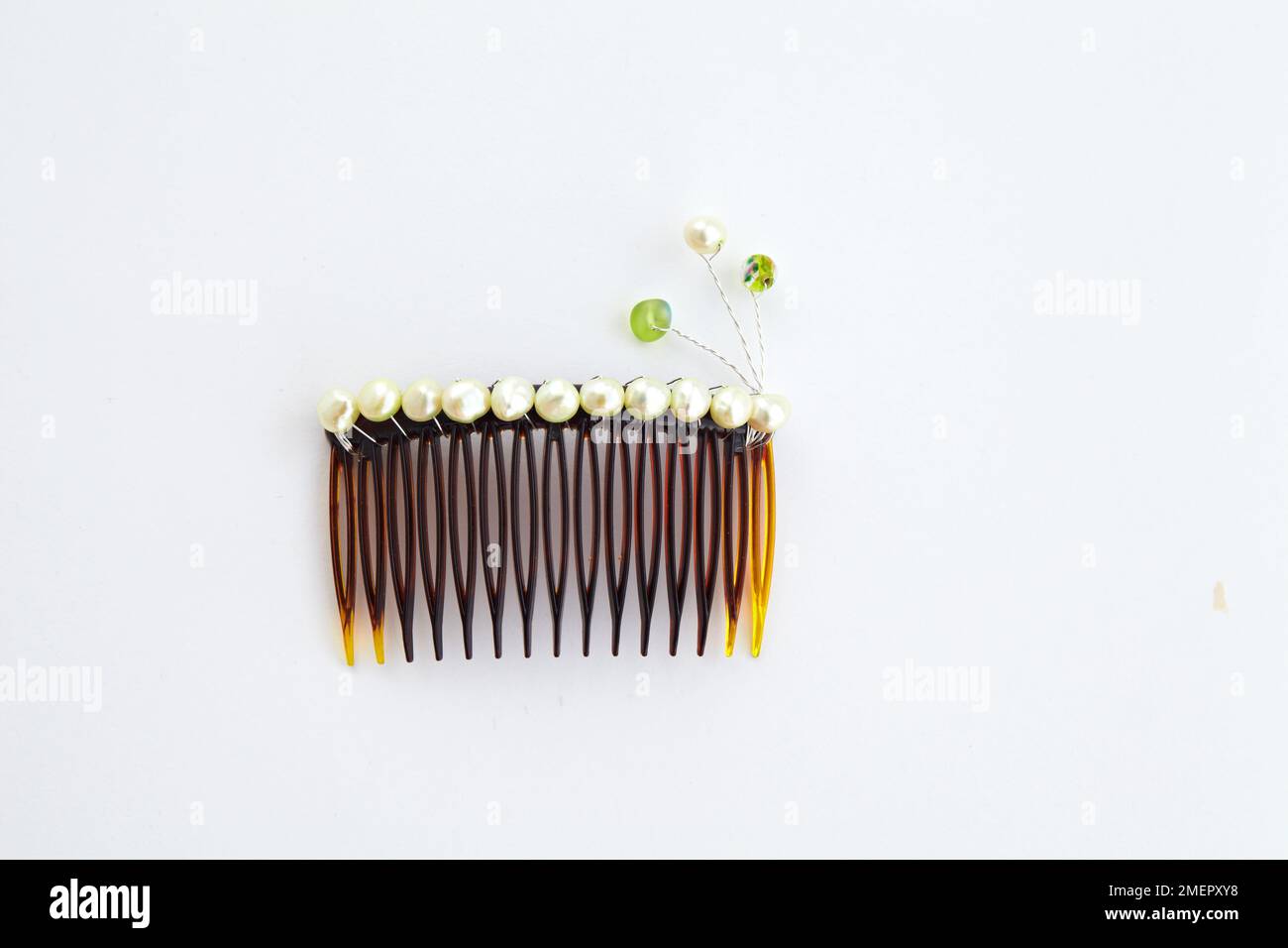 Hair comb decorated with twisted wires, overhead view Stock Photo