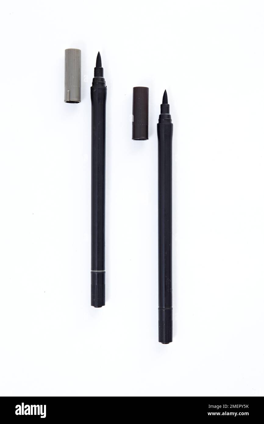 Silver and black fabric paint pens with tops removed Stock Photo Alamy