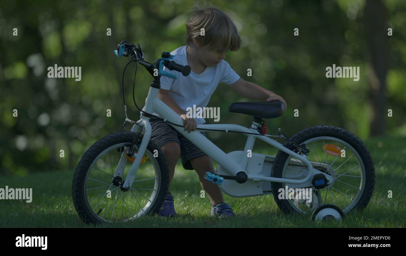 Kid Racking A Bike Child carrying stuck bicycle kid unable to move bike up a hill Stock ...