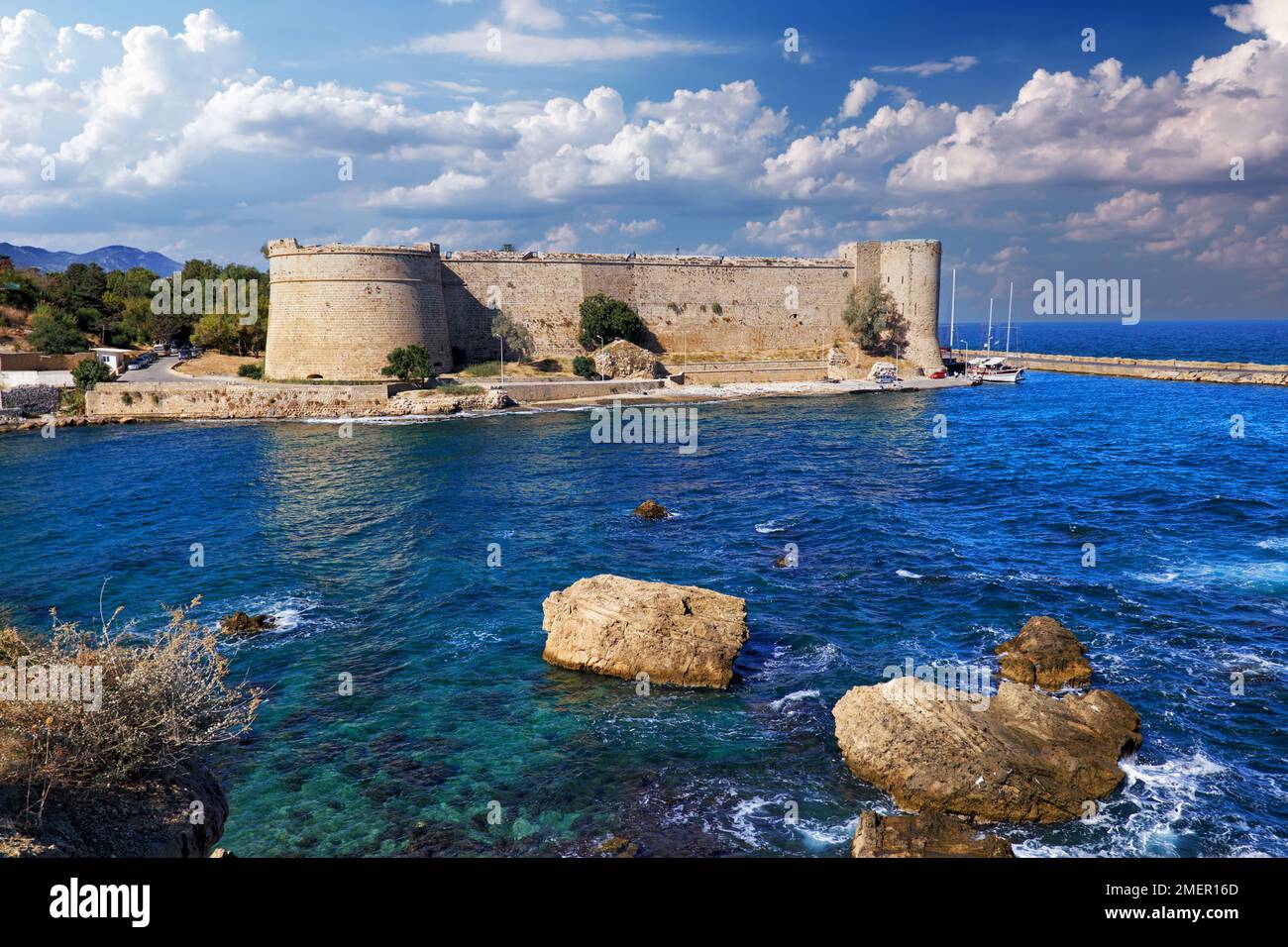 Kyrenia Castle in Northern Cyprus against the backdrop of the cloudy  sky. Picturesque landscape of the Girne Castle in Kyrenia Old harbour Stock Photo