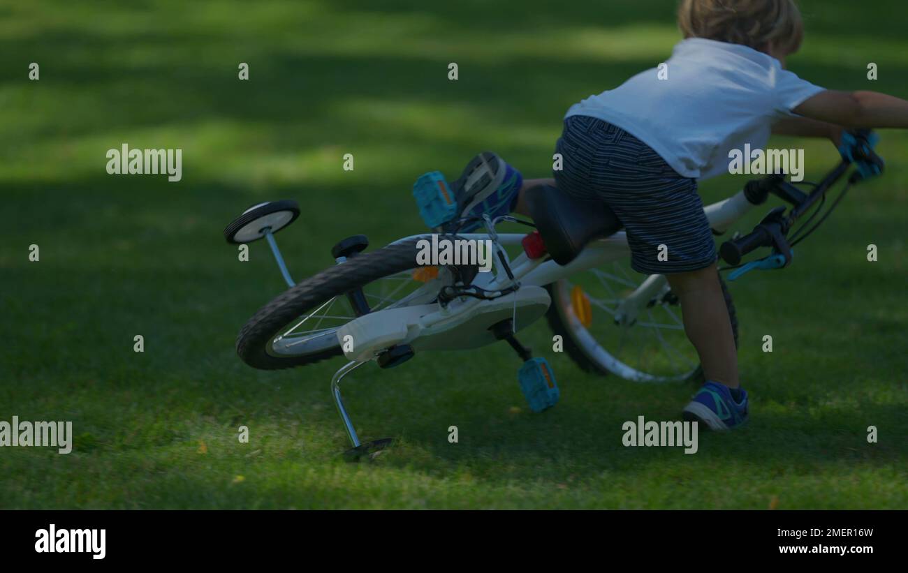 Child crashes bicycle falling to the ground kid real life accident Stock Photo Alamy