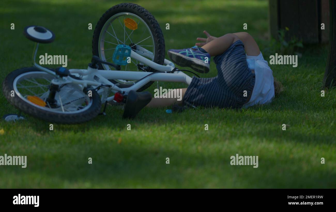 Child crashes bicycle falling to the ground kid real life accident Stock Photo Alamy