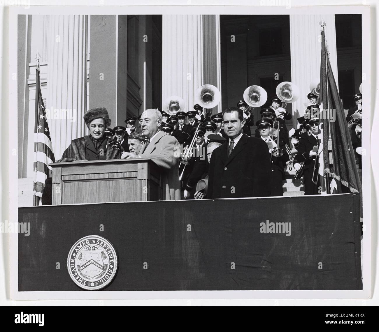 George M. Humphrey and Richard M. Nixon on Opening Day of Alexander Hamilton Bicentennial in Washington, DC. Picture shows George M. Humphrey and woman at podium and Richard Nixon standing to the left of the podium. Stock Photo