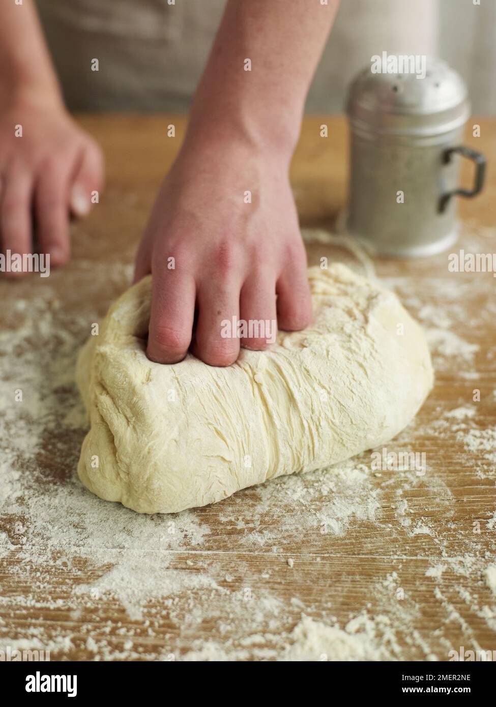Kneading bread dough on floured surface Stock Photo Alamy