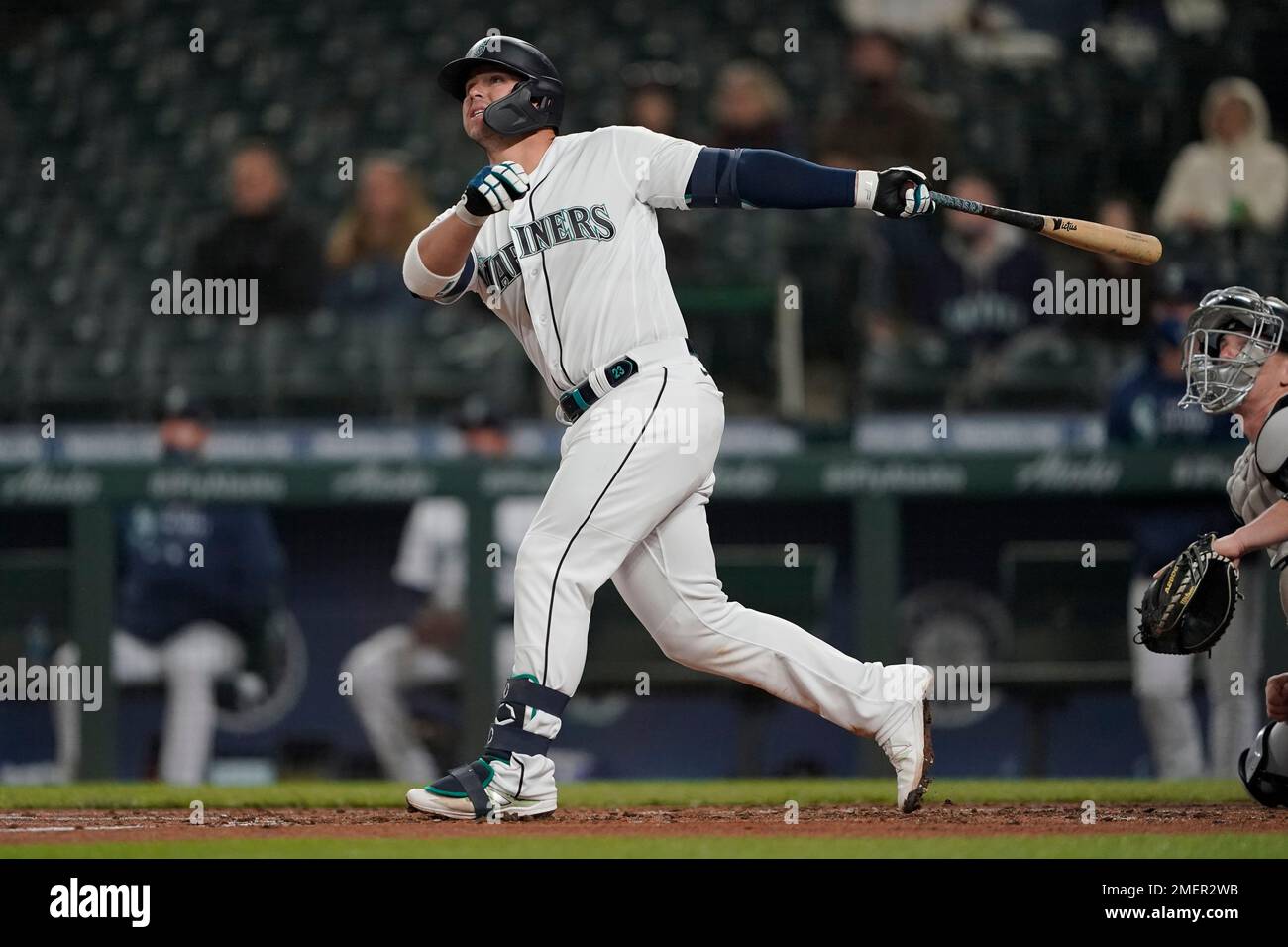 Seattle Mariners' Ty France watches the flight of his run-scoring